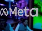 FILE PHOTO: People are seen behind a logo of Meta Platforms, during a conference in Mumbai, India, September 20, (REUTERS)