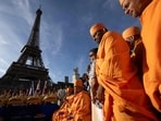 Bochasanwasi Akshar Purushottam Swaminarayan Sanstha (BAPS) Hindu monks take part in a religious ceremony in front of the Eiffel Tower before a ceremonial river parade on the river Seine in Paris.