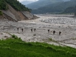 Members of Nepal Army walk towards Betrawati town for a search operation for survivors and victims of the deadly flash floods and a mudslide, in Nuwakot district, Nepal, September 6, 2026.