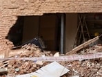 Workers install temporary iron pillars and support structures to stabilize an adjoining building. (Neeraj)