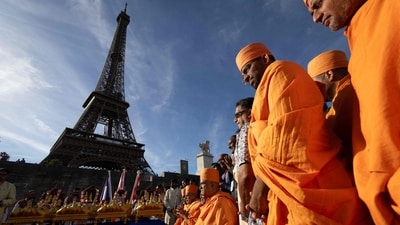Bochasanwasi Akshar Purushottam Swaminarayan Sanstha (BAPS) Hindu monks take part in a religious ceremony in front of the Eiffel Tower before a ceremonial river parade on the river Seine in Paris. (AFP)