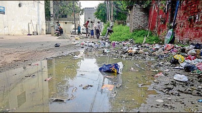 Roads in deplorable condition with garbage and encroachments near Pratap Chowk in Ludhiana on Tuesday. (Gurpreet singh/ht)