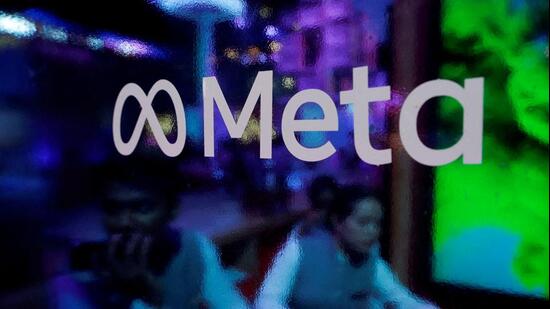 FILE PHOTO: People are seen behind a logo of Meta Platforms, during a conference in Mumbai, India, September 20, (REUTERS)