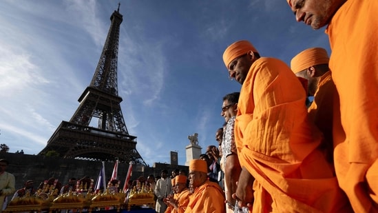 Bochasanwasi Akshar Purushottam Swaminarayan Sanstha (BAPS) Hindu monks take part in a religious ceremony in front of the Eiffel Tower before a ceremonial river parade on the river Seine in Paris.