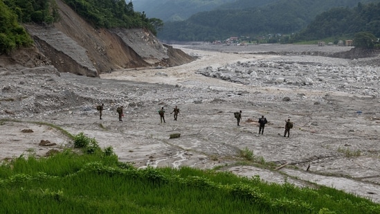 Members of Nepal Army walk towards Betrawati town for a search operation for survivors and victims of the deadly flash floods and a mudslide, in Nuwakot district, Nepal, September 6, 2026.