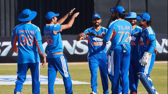 TOPSHOT - Indian players celebrate the wicket of Brian Bennet during the second Twenty20 international cricket match between Zimbabwe and India at Harare Sports Club in Harare, on July 25, 2026. (Photo by Jekesai NJIKIZANA / AFP) (AFP)