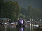 A movie is being screened on a floating cinema at the Dal Lake during the first International Film Festival in Srinagar. (Waseem Andrabi/HT)