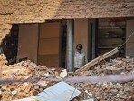 MCD personnel installing temporary structural supports in buildings adjacent to the Satya Niketan collapse site. (Sanchit Khanna/HT Photo)