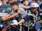 Fans call out for autographs before an NFL football game between the Seattle Seahawks and the New England Patriots, Wednesday, Sept. 9, 2026, in Seattle. (AP Photo/Lindsey Wasson)
