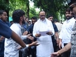 UP deputy CM Brajesh Pathak meeting protesters outside his residence in Lucknow on Tuesday. (HT Photo)