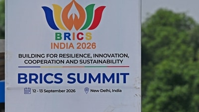 Pedestrians wait at a bus stand near a hoarding, displayed ahead of the BRICS summit in New Delhi on September 9, 2026. (Photo by Sajjad HUSSAIN / AFP) (AFP) Pedestrians wait at a bus stand near a hoarding, displayed ahead of the BRICS summit in New Delhi on September 9, 2026. (Photo by Sajjad HUSSAIN / AFP) (AFP)