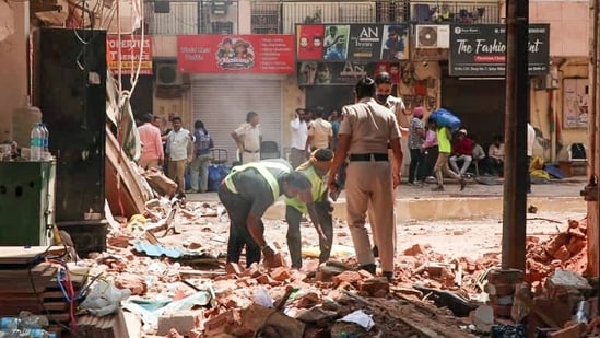 Delhi building collapse LIVE: Workers clear the debris in the presence of security personnel at the site of the Satya Niketan building collapse (6th Sep), in New Delhi on Tuesday. Delhi building collapse LIVE: Workers clear the debris in the presence of security personnel at the site of the Satya Niketan building collapse (6th Sep), in New Delhi on Tuesday.