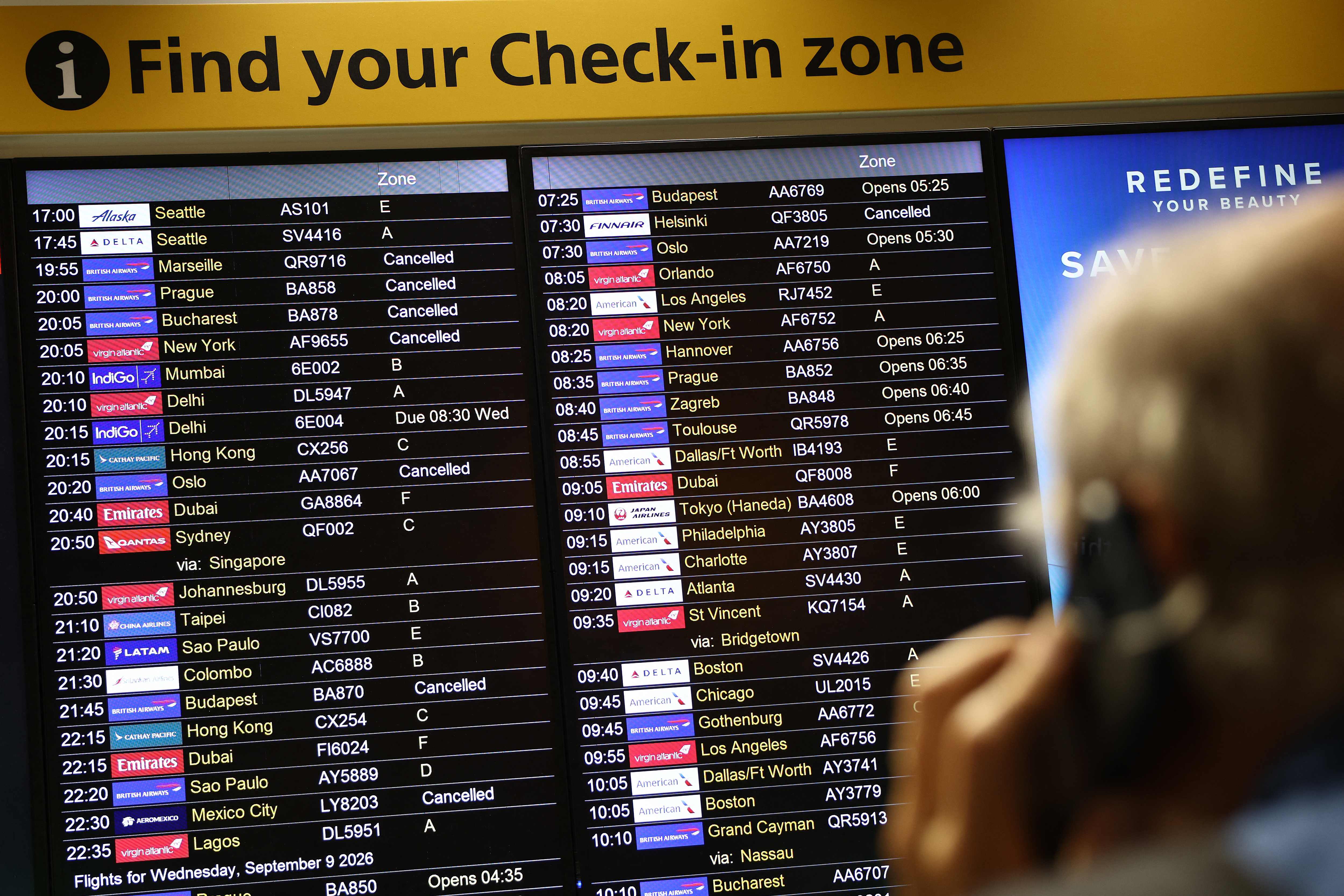 Cancelled flights are pictured on an electronic check-in display board at Terminal 3 of London Heathrow airport, west of London. (AFP)