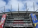 A general overall view of the Melbourne Cricket Ground with images of San Francisco 49ers running back Christian McCaffrey (23) and Los Angeles Rams quarterback Matthew Stafford (9) on the facade. (IMAGN IMAGES via Reuters Connect)