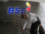 A man touches the stairs as he arrives at the Bombay Stock Exchange (BSE) building in Mumbai