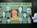 An artist gives final touches to paintings of BRICS member countries' leaders in Amritsar on September 10,