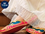 Bright pink Ghunghroo Ballet Juttis paired with an ivory lehenga for a night of comfortable dancing on the dance floor.