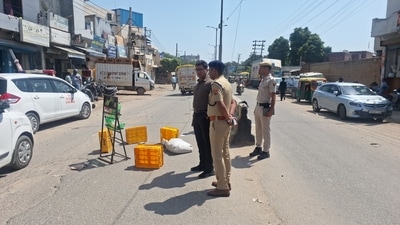 Police personnel at the site where the 40-year-old contractor was killed on Gurugram's Bassi Road. (HT Photo/ Parveen Kumar)