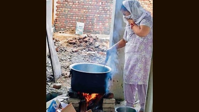 A mid-day meal worker cooking food on firewood at a government school in Ludhiana on Thursday. (HT PHOTO) A mid-day meal worker cooking food on firewood at a government school in Ludhiana on Thursday. (HT PHOTO)