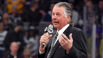FILE - Former Los Angeles Kings coach Barry Melrose speaks to fans as he is honored prior to an NHL hockey game between the Kings and the Calgary Flames, on Feb. 12, 2015, in Los Angeles. (AP Photo/Mark J. Terrill, File) (AP Photo/Mark J. Terrill)