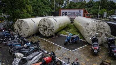 The three tanks—about seven metres long and two metres wide—are lying horizontally in the exhibition centre premises, on a pathway and lawn next to the parking area. (Satish Bate/Hindustan Times)
