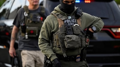 An Immigration and Customs Enforcement (ICE) agent looks on as an individual is detained outside a home in Danbury, Connecticut, U.S., August 27, 2026. (REUTERS FILE)