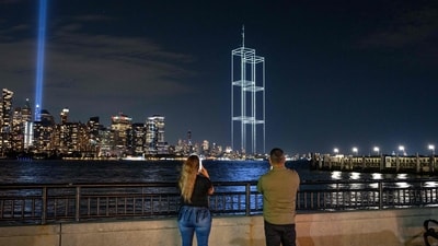 People watch and take pictures as a drone light show depicting the twin towers appears in the skyline during testing of Tribute in Light installation in lower Manhattan on September 9, 2026, as seen from Liberty State Park in Jersey City, New Jersey. The twin beams shine from dusk on September 11 until dawn on September 12 every year. Jeremy Weine/Getty Images/AFP (Photo by Jeremy Weine / GETTY IMAGES NORTH AMERICA / Getty Images via AFP) (Getty Images via AFP) People watch and take pictures as a drone light show depicting the twin towers appears in the skyline during testing of Tribute in Light installation in lower Manhattan on September 9, 2026, as seen from Liberty State Park in Jersey City, New Jersey. The twin beams shine from dusk on September 11 until dawn on September 12 every year. Jeremy Weine/Getty Images/AFP (Photo by Jeremy Weine / GETTY IMAGES NORTH AMERICA / Getty Images via AFP) (Getty Images via AFP)