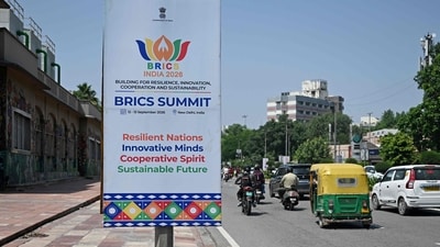 Traffic moves along a street past a hoarding, displayed ahead of the BRICS summit in New Delhi on September 9, 2026. (Photo by Sajjad HUSSAIN / AFP) (AFP) Traffic moves along a street past a hoarding, displayed ahead of the BRICS summit in New Delhi on September 9, 2026. (Photo by Sajjad HUSSAIN / AFP) (AFP)