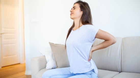 Back pain in people in their 20s is rising due to extended sitting, poor ergonomics, and sudden exercise. (Freepik)