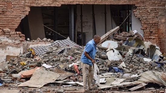 Seven persons, mostly students, died on September 6 after a multi-storey building crashed in Delhi's Satya Niketan.(In picture: A worker at the building collapse site)