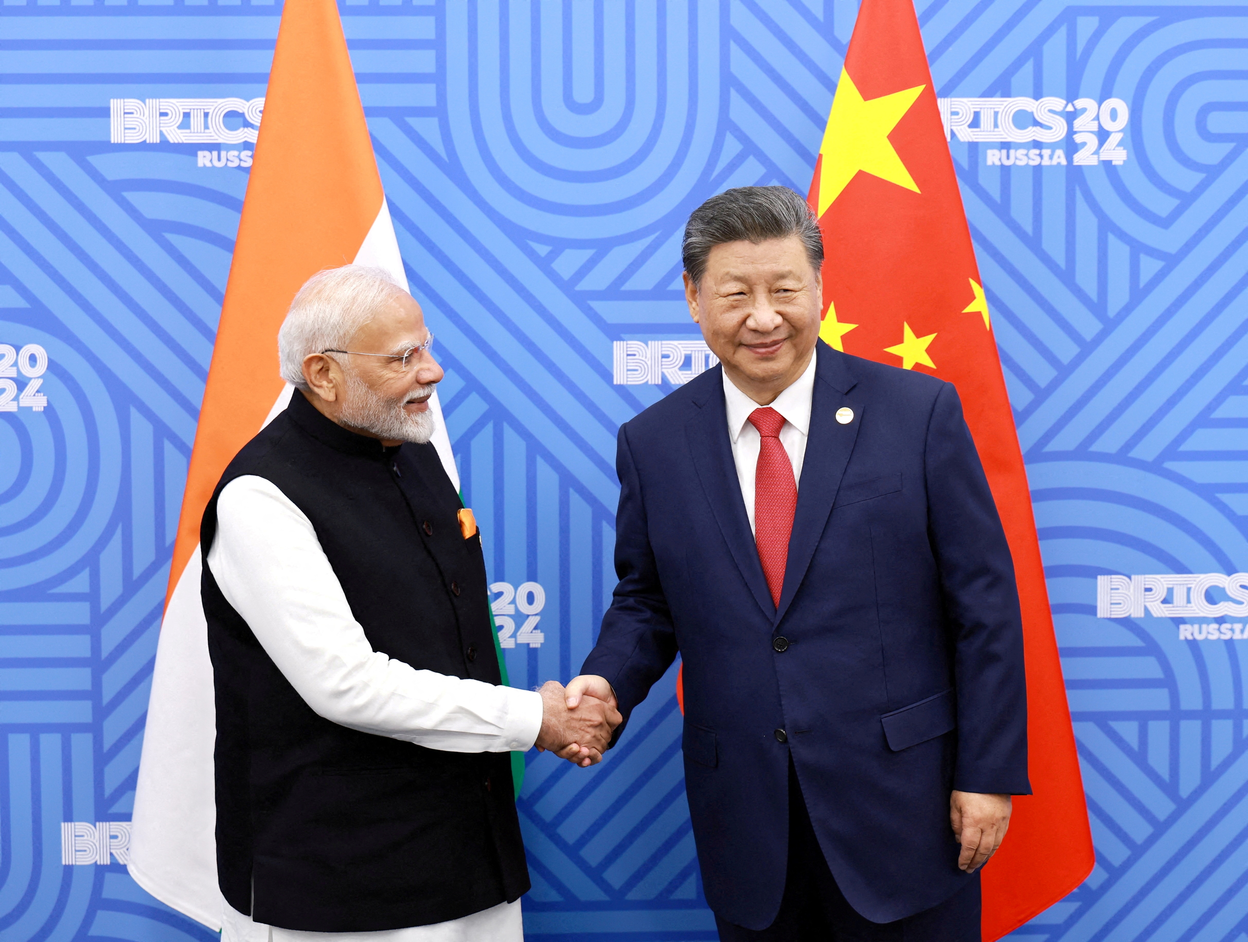 Chinese President Xi Jinping and India Prime Minister Narendra Modi meet on the sidelines of the BRICS summit in Kazan, Russia October 23, 2024. (CHINA DAILY VIA REUTERS)