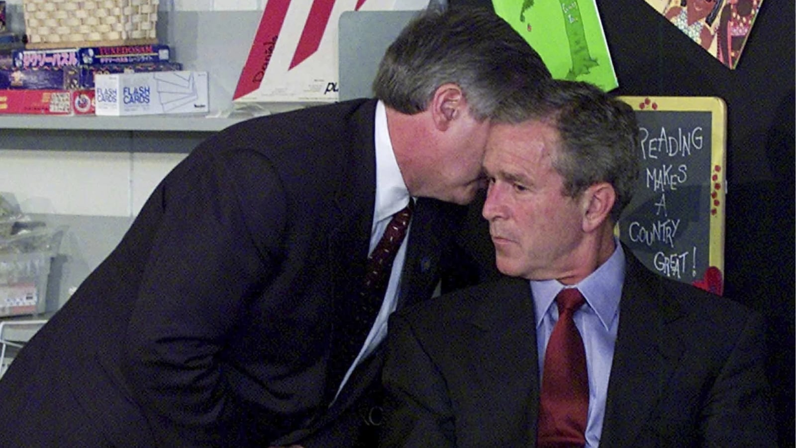 Chief of Staff Andy Card tells George W Bush about the plane crashing into the World Trade Centre during a visit to the Emma E Booker Elementary School (AP)