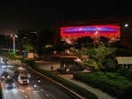 Traffic moves past the illuminated Bharat Mandapam, the venue for the BRICS summit, in New Delhi.