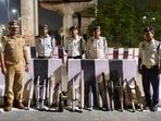 Traffic police personnel with the seized modified bike silencers removed during a crackdown. (Sourced)