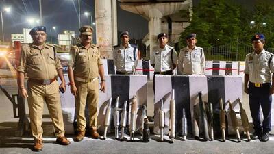 Traffic police personnel with the seized modified bike silencers removed during a crackdown. (Sourced)