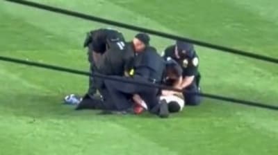 A man identified as Kelly Marcucci, 38, was charged for invading the field at a Yankees-Mets game while chanting and displaying a 'No Kings' jersey./