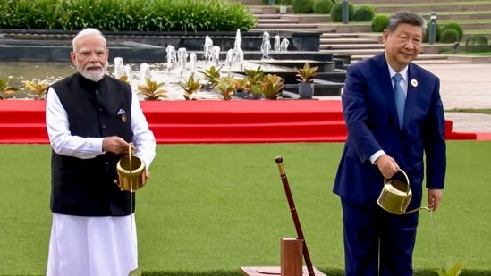 Prime Minister Narendra Modi with Chinese President Xi Jinping during a joint tree plantation initiative amid the ongoing 18th BRICS Summit, at the Bharat Mandapam, in New Delhi.