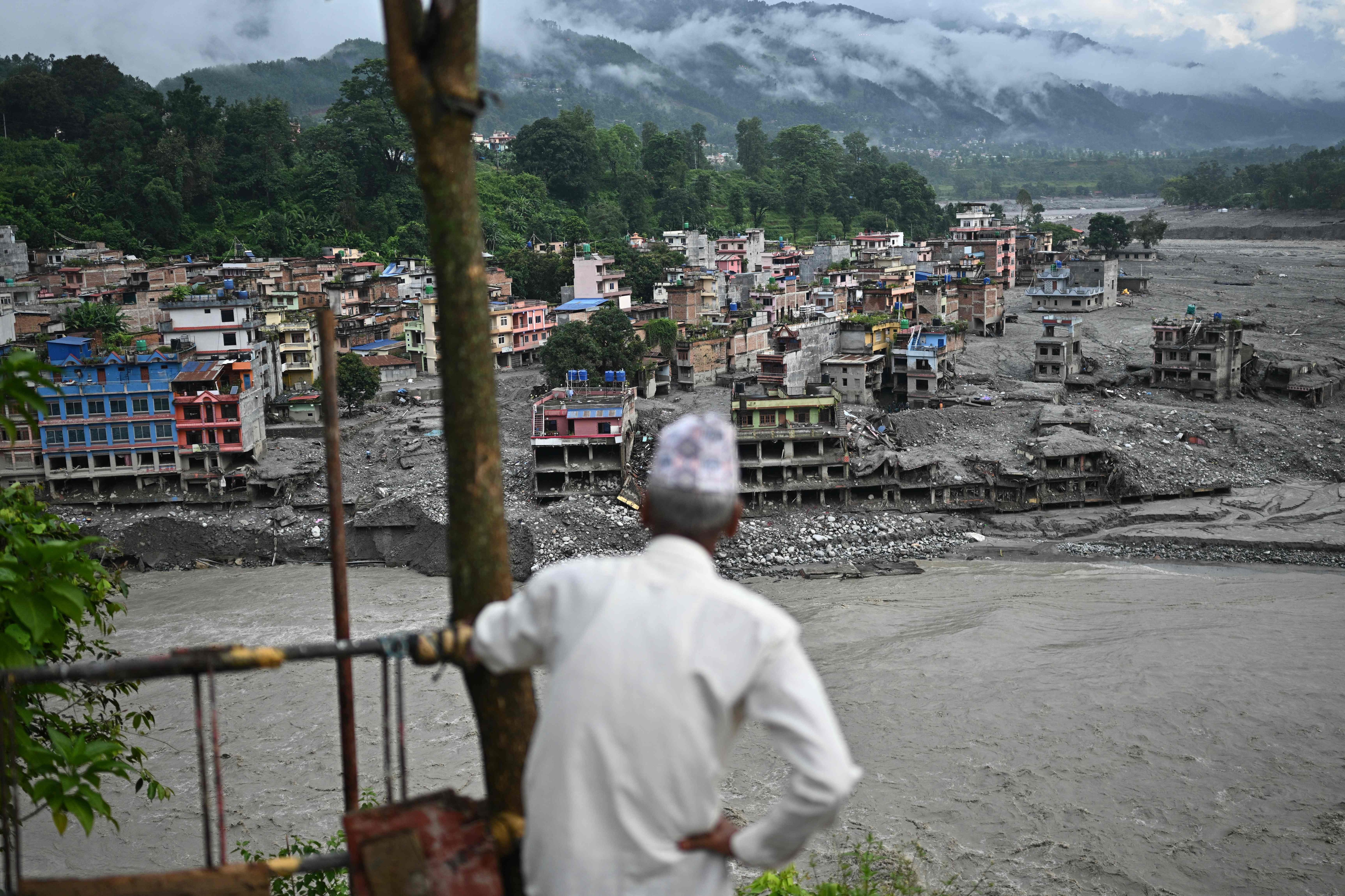 A man looks at the remains in the aftermath of flash floods at Trishuli in Nepal's Nuwakot district on September 7, 2026. (File Photo/AFP) A man looks at the remains in the aftermath of flash floods at Trishuli in Nepal's Nuwakot district on September 7, 2026. (File Photo/AFP)