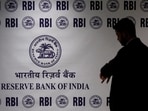 Man stands in front of the Reserve Bank of India (RBI) logo inside its headquarters in Mumbai, India, February 6, 2026. 