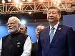  Prime Minister Narendra Modi (L) stands alongside China's President Xi Jinping during the 18th BRICS Summit in New Delhi.(AFP)