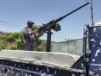 A member of the Saudi-backed Yemeni government forces, including National Army and Taiz Axis forces, mans a turret mounted on the back of a pickup truck at a checkpoint along the Kadha frontline west of Taiz in western Yemen on September 13, 2026. 