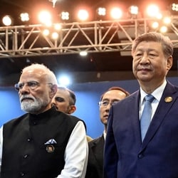  Prime Minister Narendra Modi (L) stands alongside China's President Xi Jinping during the 18th BRICS Summit in New Delhi.