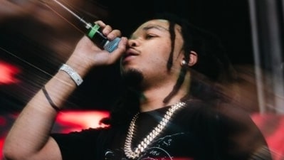 Chicago drill rapper BloodHound Q50 was fatally shot by six gunmen at a gas station in Fuller Park, with over 50 rounds fired.