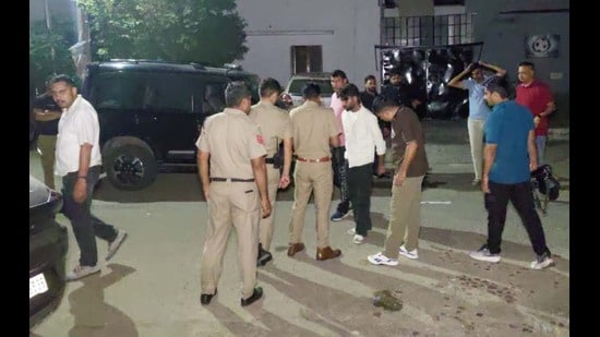 Police officials outside the club where the firing took place in Panchkula. (Sant Arora/HT)
