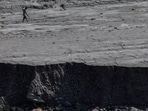 A man walks along a mud-covered riverbank following deadly flash floods and mudslides, in Dhading district, Nepal, September 14, 2026.(REUTERS)