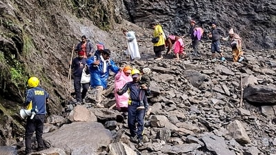 SDRF personnel evacuate stranded pilgrims after debris and stones temporarily closed the Kedarnath Yatra trekking route near Chirbasa helipad, in Rudraprayag. (PTI)