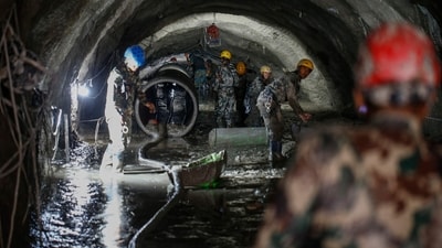 The Nepali Army conducts a search-and-rescue operation inside the Chilime Hydropower Station tunnel days after deadly flash floods and mudslides in Nepal's Rasuwa district. (AFP)