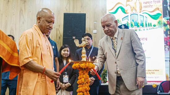 Chief minister Yogi Adityanath and Lokayukta Justice Sanjay Mishra light the ceremonial lamp during the 50th Foundation Day ceremony of the Lokayukta Organisation, in Lucknow on Monday. (ANI PHOTO)