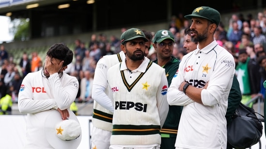 Pakistan's Babar Azam, center, with teammates following his side's defeat to England on day four of the third cricket Test at Edgbaston, 