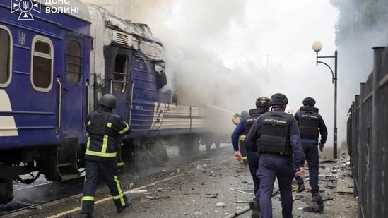 Firefighters extinguish a car of a passenger train hit by a Russian drone strike at a railway station, Lutsk, Ukraine, Sept. 12.